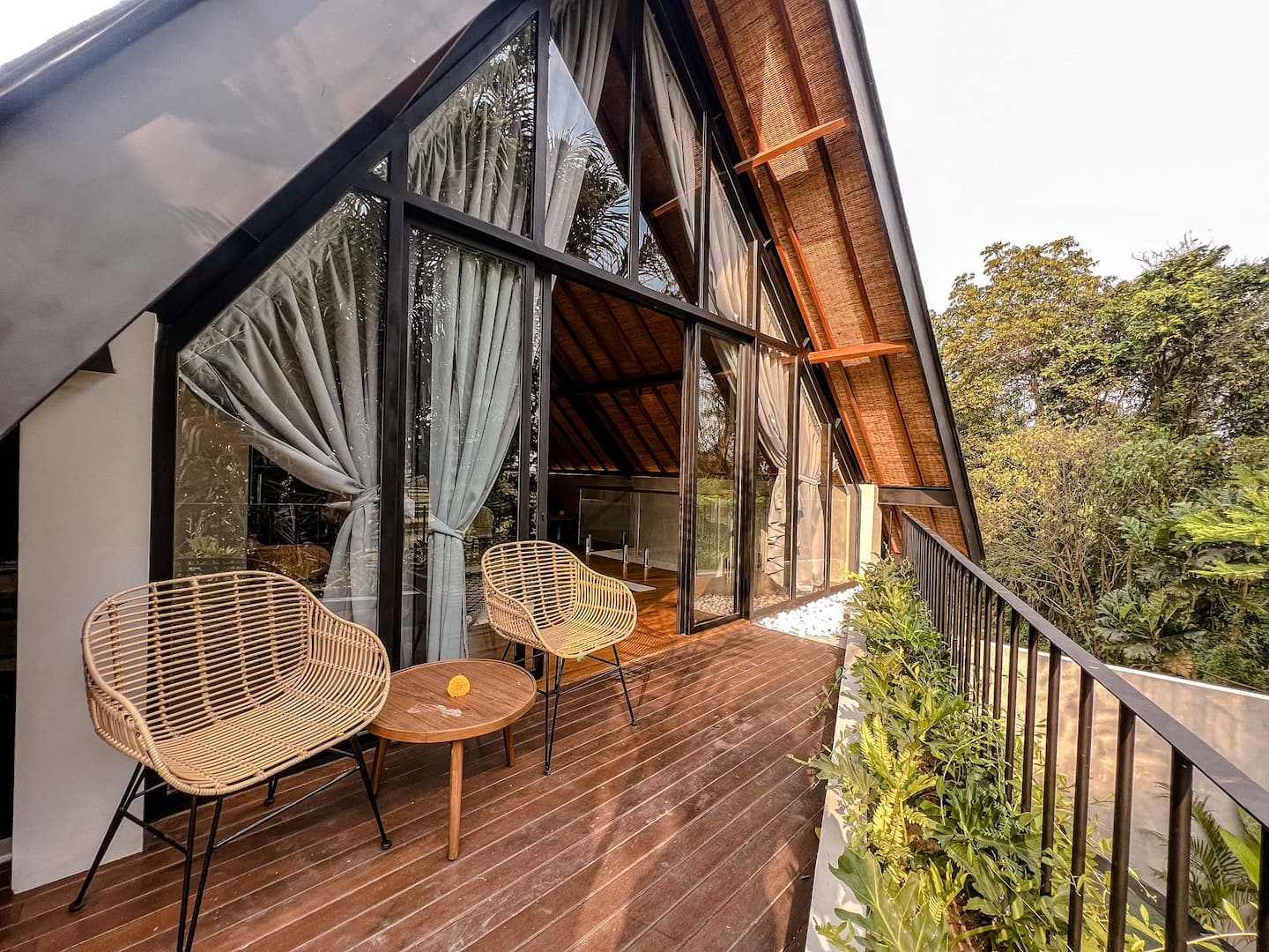 Balcony with rattan chairs over the garden