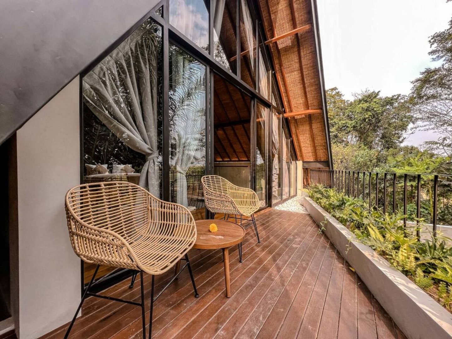 Rattan chairs on the upper deck over the garden